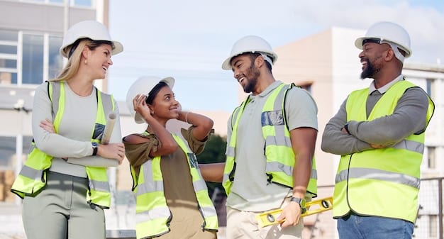 A diverse group of construction workers collaborating on a project site. They are wearing safety gear and using modern equipment. The background shows a partially completed structure, symbolizing the ongoing infrastructure development.