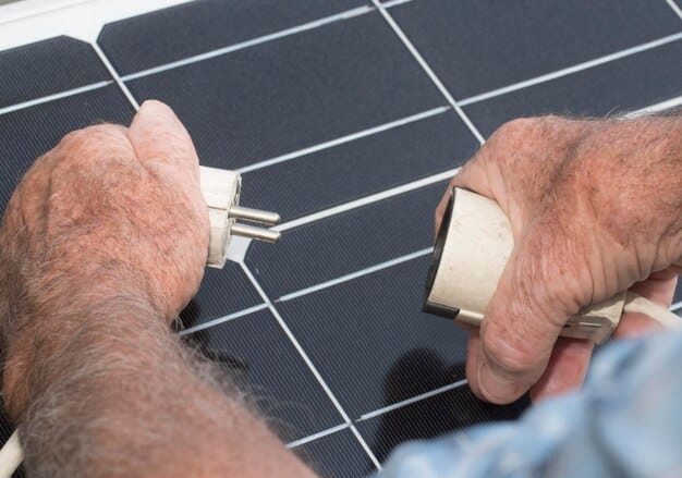 A close-up shot of solar panels being installed on a residential rooftop, capturing the hands of the installers and the intricate details of the panel setup. The image highlights the accessibility and growing trend of residential solar installations supported by government subsidies.