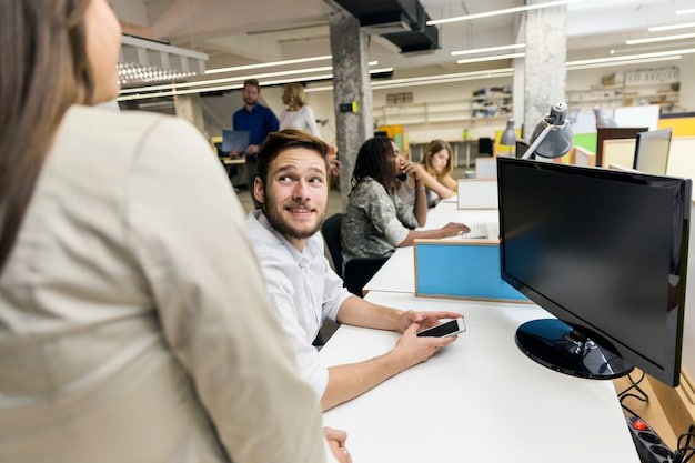 A classroom setting inside a manufacturing plant, where employees are learning about new software or machinery. The image emphasizes the importance of continuous training and workforce development in the manufacturing sector.