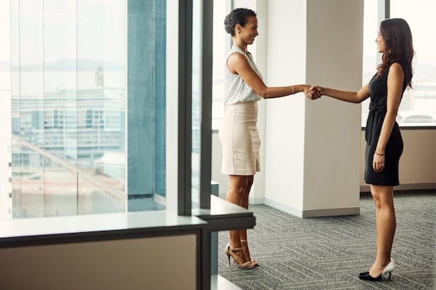 An American businesswoman shaking hands with a Japanese businessman in a modern office setting. Both are smiling and dressed in professional attire. The background includes a minimalist office design, with soft lighting and a few potted plants, suggesting a blend of cultures.