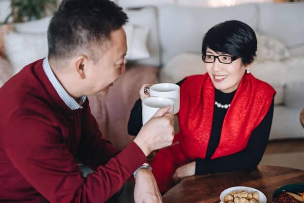 Two business people, one from the US and one from China, sharing tea in a traditional Chinese teahouse. They are both smiling and engaged in a relaxed conversation. The teahouse is decorated with traditional Chinese art and calligraphy, with soft, natural lighting that creates a warm and inviting atmosphere.
