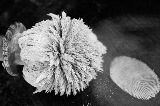 A close-up shot of a sample of self-healing concrete under a microscope, showcasing the microscopic capsules containing healing agents. Some capsules are broken, releasing the agents to fill cracks in the concrete, illustrating the self-repair process.