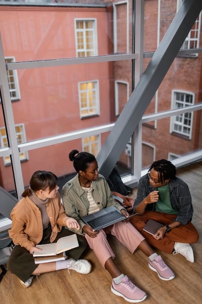 A group of international students studying together on a US university campus, symbolizing the exchange of ideas and values through education.