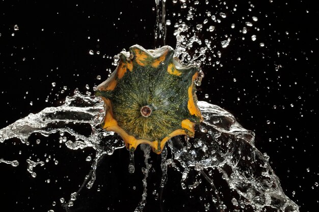 A close-up of a dripping faucet, with a slow-motion effect highlighting individual water drops, emphasizing water waste.
