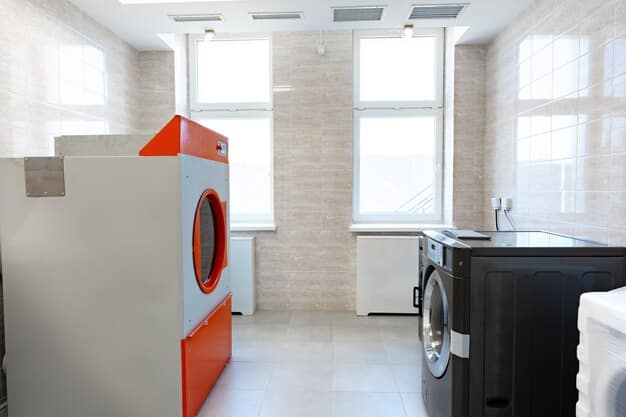 A clean and modern laundry room with a shiny, new energy-efficient front-load washing machine and dryer, both featuring prominent Energy Star labels. A basket of freshly laundered clothes sits next to them.