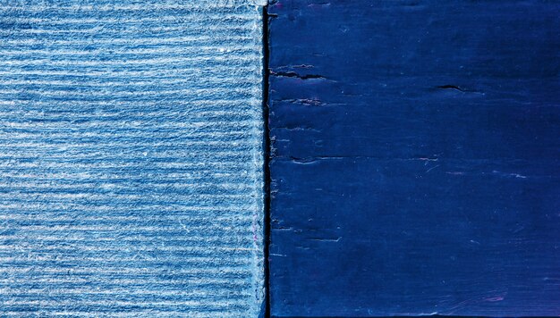 A close-up view of a wall section demonstrating eco-friendly insulation made from recycled denim, showing its fibrous, blue material and texture.