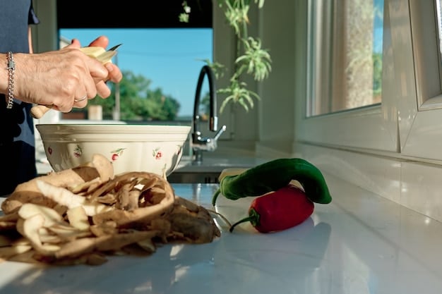 A person carefully sorting vegetable scraps into a small counter-top compost bin in a modern, sunlit kitchen.