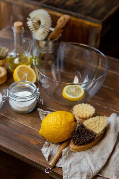 A close-up shot of a variety of natural ingredients like baking soda, white vinegar, lemon, and essential oils arranged on a wooden surface, suggesting homemade cleaning solutions.