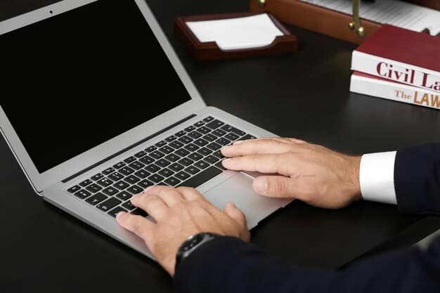 A close-up of hands typing on a laptop keyboard, with blurry financial charts and legal documents in the background, symbolizing the administrative and financial aspects of policy changes for businesses and workers.
