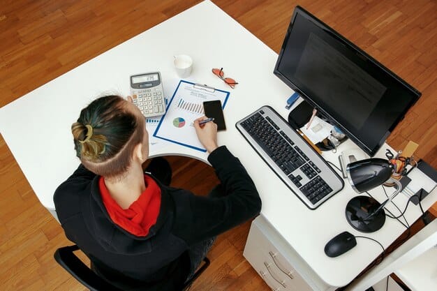 A person sitting at a desk, surrounded by digital marketing tools and screens, deeply focused on creating engaging content. The scene highlights creativity, strategic planning, and the dynamic nature of digital content creation.