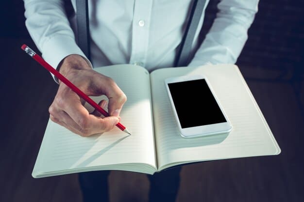 A person's hand holding a pen, making notes on a proposal document titled 