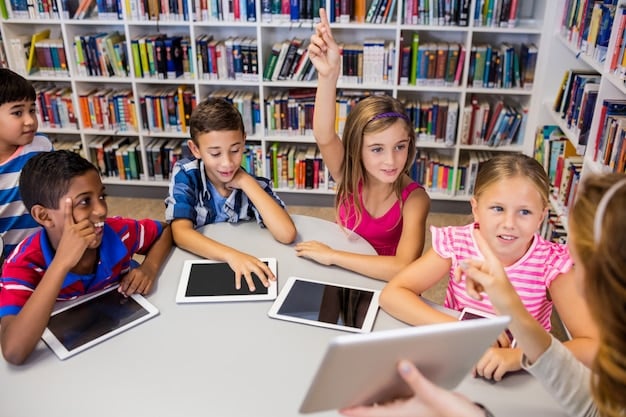 A school library or media center filled with students using a mix of laptops, tablets, and desktop computers, with a teacher assisting, emphasizing accessible technology for all students regardless of socioeconomic background.