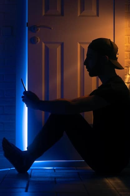 A young person sitting alone, illuminated by the blue light of a phone screen, with subtle shadows suggesting feelings of isolation and sadness. Relevant to the section on negative impacts.
