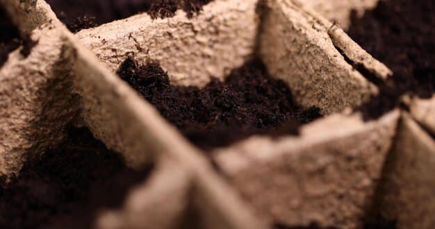 A detailed close-up of healthy, dark brown, crumbly compost with visible organic matter remnants, showing its rich texture ready for garden use.
