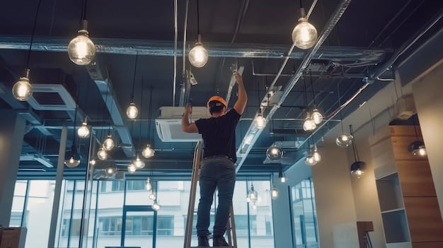 An electrician installing LED lighting fixtures in a commercial office space, highlighting the ease of installation and upgrade process. The background shows other workers and office equipment, demonstrating a typical business environment. Can Switching to LED Lighting Save US Businesses 15% on Energy Bills by the End of 2025?