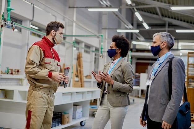 A diverse team of engineers and sustainability experts collaborating in a modern, well-lit factory, reviewing data on tablets and discussing ways to optimize energy efficiency and reduce waste. The scene illustrates the proactive approach needed to comply with the New EPA Regulations: How Will They Impact US Manufacturing's Sustainability Practices in 2025?.