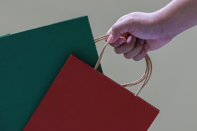A close-up shot of a shopper's hands holding two packages: one made of recycled cardboard and the other of single-use plastic. The focus is on the textures and labels indicating the materials used.