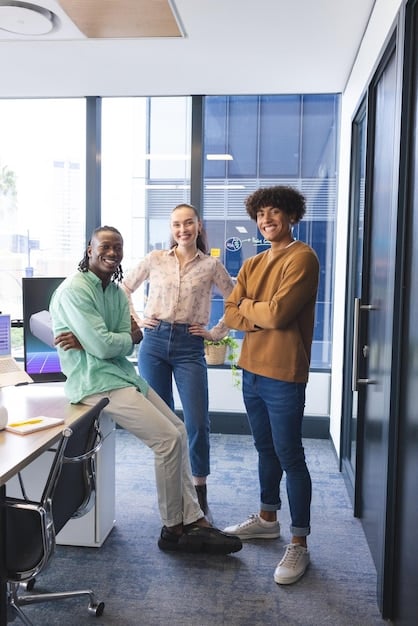 A diverse team of employees collaborating happily in an open-plan office, symbolizing low employee turnover and a positive work environment.