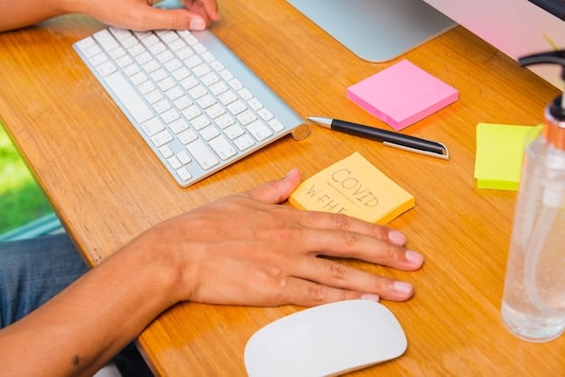 A person using a laptop while sitting at a well-lit desk with sticky notes displaying various skills such as
